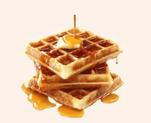 Golden waffles topped with butter and a drizzle of syrup